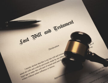 Will and testament beside a wooden gavel.